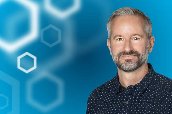 Dr. Trent Dawson over a gradient blue background and white hexagons on the right. 